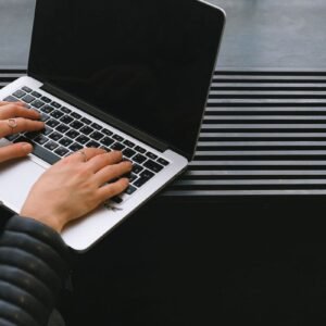 Hands typing on a laptop during digital work