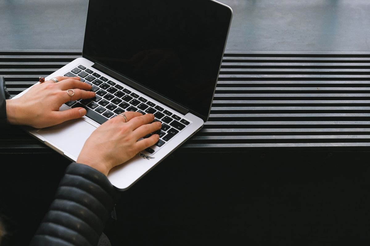 Website Speed Optimization 1 Hands typing on a laptop during digital work