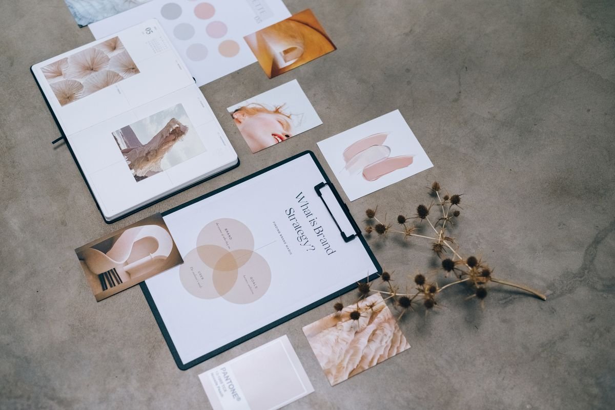 Brand Identity and Digital Guidelines 1 Branding documents and design materials on a desk