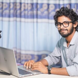 Web developer working on a laptop in an office